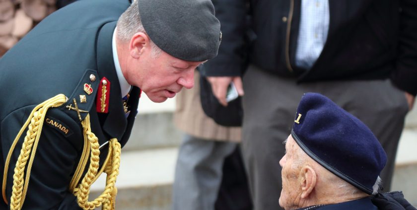 Chief of Defence Staff General Jonathan Vance talks with a veteran following the annual Remembrance Day ceremony at the National War Memorial.